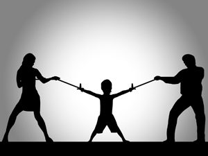 The effects of divorce on children - parents pulling at both sides of child