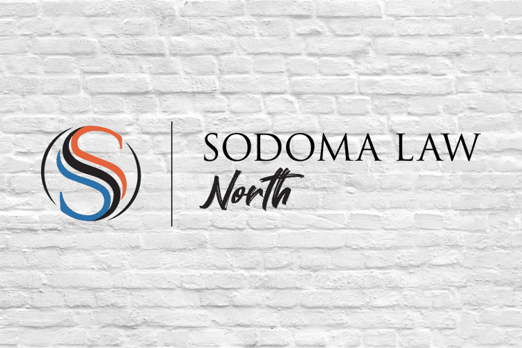 Sodoma Law North Logo on White Brick Wall